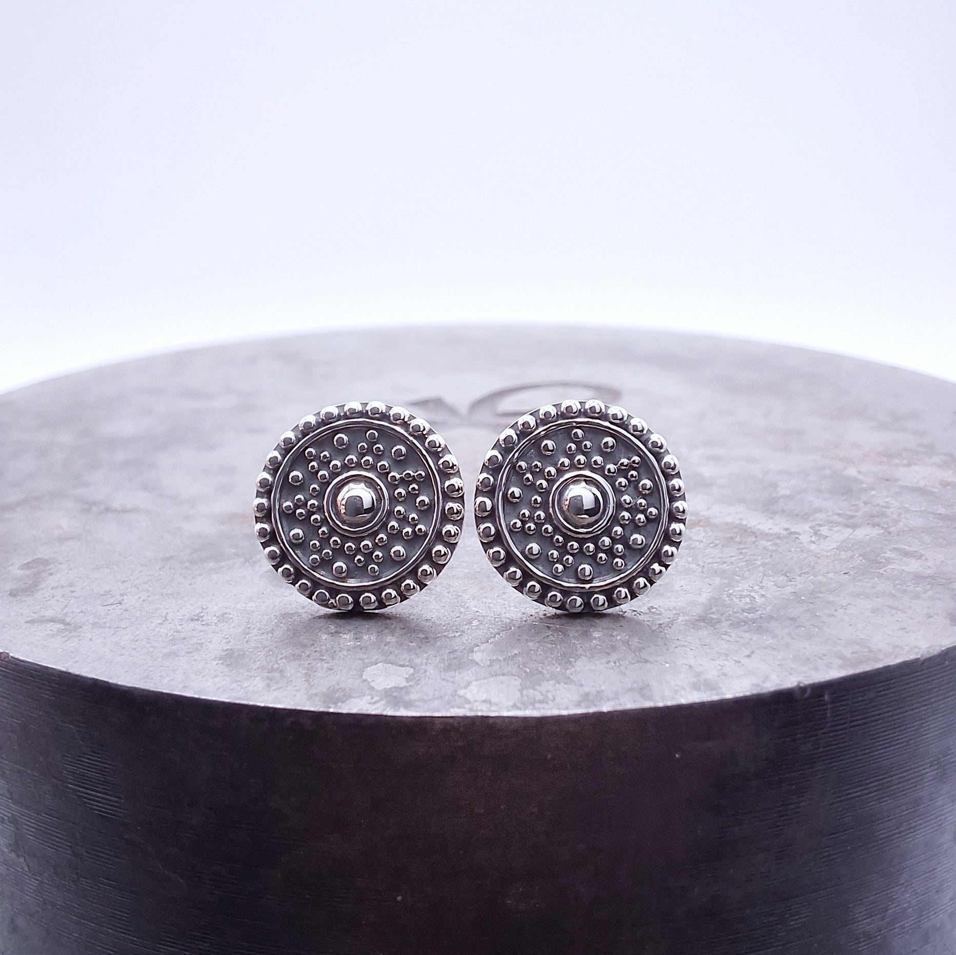 Sterling silver Mandala studs.

A symbol in budhism representing the perfect universe.  