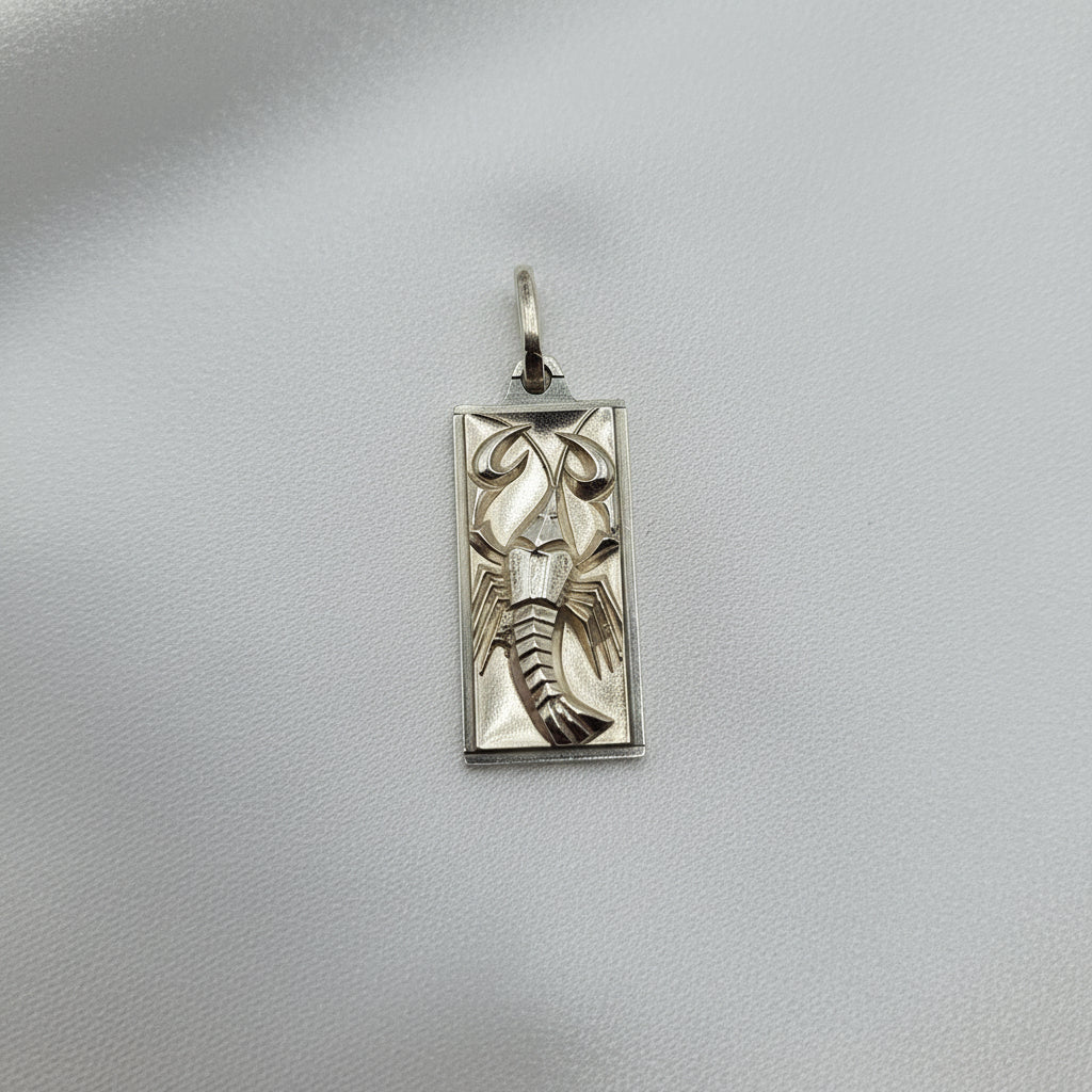 Silver pendant with lobster design on a gray background